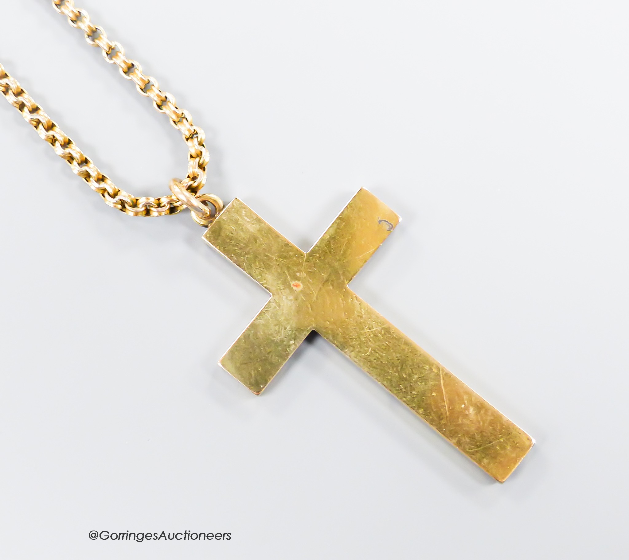 A hollow yellow metal cross pendant, 53mm, together with an Edwardian yellow metal choker chain, stamped 9c, 34cm